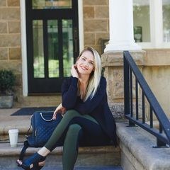 McCall Alldredge seated on the front steps of a home